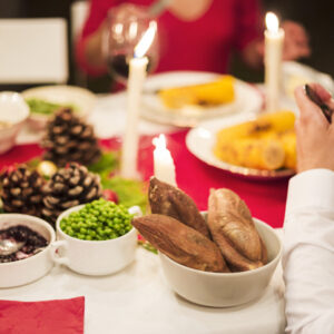 hand-person-eating-festive-table_23-2147969509